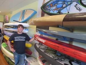 Delmarva Board Sport Adventures co-owner George Markopoulis shows off some of his collection at the paddleboard store. BY MOLLY MACMILLAN