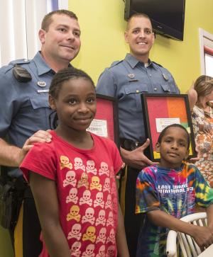 Children in the program made a thank you gift for Cpl. Matthew Blakeman and Tfc. Patrick Jackson. Presenting the gift are Tymiah, left, and Neamiah Jackson. BY DENY HOWETH