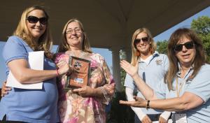 Linda Risk, director, (l-r) sponsor award recipient Sheila Morrow, Pot Nets Communities, Taylor DeMario, team coordinator, and Kate Cowperthwait, president, present an award for 2014. BY DENY HOWETH