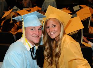Twin siblings Austin and Amanda Smith smile for the camera while waiting for the processional line up. BY DAN COOK