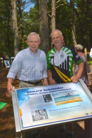 John, left, and Rob Schroeder stand behind a trail marker dedicated to their father, Howard. The two are still active in Cape Region environmental issues, a trait they learned as children. BY RON MACARTHUR