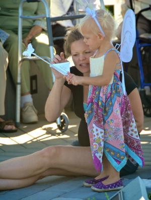 Natalie Bernier of Nashville, Tenn., explains to her daughter, Olivette, how to let the monarch butterfly out of its envelope. Olivette is the great-granddaughter of Cadbury residents Ruth and John Folta. BY RON MACARTHUR