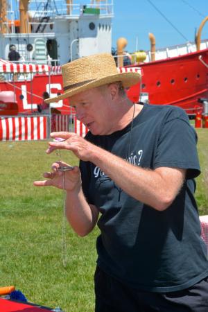 Lewes magician Charlie Joseph does some slight of hand for children during the picnic. BY RON MACARTHUR