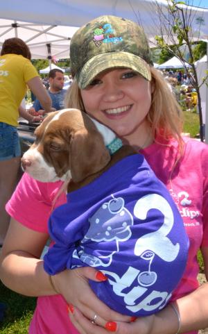 Chelsey Wagner of 2 Dips takes a break from scooping ice cream to cuddle with Dixie. BY RON MACARTHUR