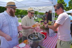Jesse Stasi, left, and Ian Crandall of Kindle serve a lobster salad sandwich to Andrew Moroz of Lynchburg, Va. BY RON MACARTHUR