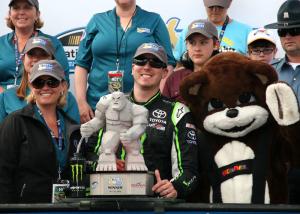 Kyle Busch receives the Miles the Monster trophy from members of the Delaware Office for Highway Safety after winning Saturday's Nationwide Series race in Dover. BY PAT IRELAN