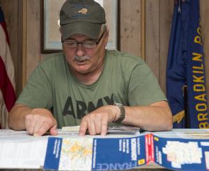 Hohman gets out a map of France and points to places he visited on his trip to Normandy for the 70th anniversary of the D-Day invasion. BY DENY HOWETH