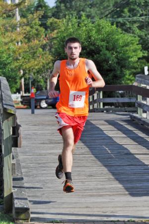 Steven Eshelman, 20, of Lincoln cruises to the win in 17:57, nearly a minute and a half faster than the second-place runner. BY NICK ROTH