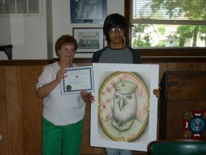 Rehoboth VFW Post 7447 Ladies Auxiliary President Elsie McGurgan holds the Department of Delaware VFW Ladies Auxiliary Honorable Mention certificate, announced at the recent Department of Delaware VFW Convention, as Francisco Madera, recent Cape Henlopen High School graduate, shows his winning original artwork. SOURCE SUBMITTED
