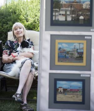 Milton painter Kathy Buschi takes a break with her dog Zachary. BY DENY HOWETH