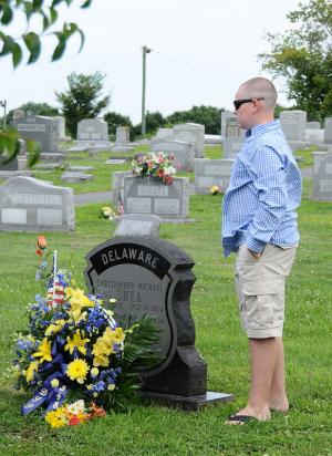 Delaware State Police Cpl. Christoper Shea's son Chris,13, looks over his father's gravestone during the Celebration of Life. BY DAN COOK