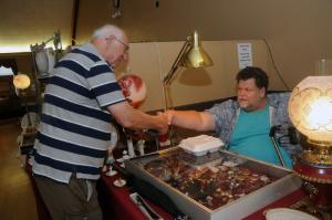 Charles Christen, visiting from Arizona, shakes the hand of Kevin Garker of Delaware Avenue Art of Laurel. BY STEVEN BILLUPS