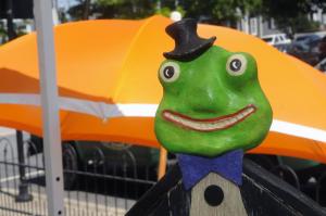 Fred the Frog stands out in front of the orange umbrella behind folk artist David Scott Ennis' booth. BY STEVEN BILLUPS