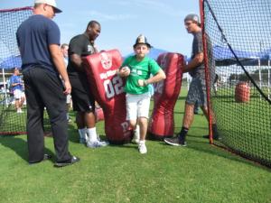 Working on football safety precautions, 11-year-old Joshua Dodd creates his own running space, breaking through members of the Sussex Tech football team (l-r) Riley Parker, Ityre Eley and Ryan Parker. BY TAGGART HOUCK
