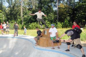 Dedicating the Luke Benson Memorial by leaping off the memorial into the bowl is Ben Cameron. Sitting on the memorial are the builders of the memorial from Big Boulder Pond Company in Milton, employee Joey Cherico, left, and owner Ryan Bunting. BY STEVEN BILLUPS