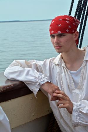 Simon Hocker, volunteer trainee, enjoys the scenery of the Delaware Bay during a brief respite from duties aboard the ship. BY RON MACARTHUR