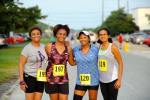 A quartet of Black Girls Run members (l-r) Gloria Meade, Jasmine Meade, Adrienne Carruth and Whitney Carruth include the Run for the Paws in their annual weekend get-together. BY DAVE FREDERICK