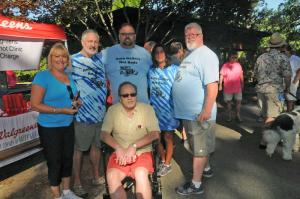 The Auto Gallery Hot Rods gather for a pre-walk photo. Shown are (l-r) Barb Kessler, Ben Rowland, Bryan Hecksher, Diane Casapulla and Mark Noble. In front is Reynolds, a 32 year survivor of HIV. BY STEVEN BILLUPS