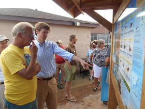 Slaughter Beach resident Bill McSpadden, left, and NWF President and CEO Collin O'Mara check out the recently unveiled environmental display kiosk May 30. BY MADDY LAURIA