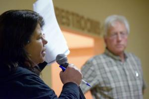 Maria Payan of the Socially Responsible Agriculture Project questions why an out-of-state poultry project was included in an environmental assessment report for the Harbeson plant's construction plans. BY MADDY LAURIA