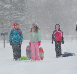 Youngsters brave the cold to find a sledding spot as they leave Covey Creek near Lewes. RON MACARTHUR PHOTO