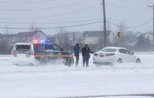 A Delaware State Police officer helps a stranded motorist near Five Points in Lewes. NICK ROTH PHOTO