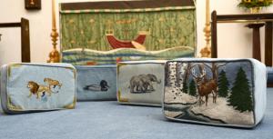 Wildlife portrayed on the kneelers includes a variety of ducks, lions, and more. The six-point buck on a snow-covered bank among birch trees and evergreens is one of the more intricate designs.