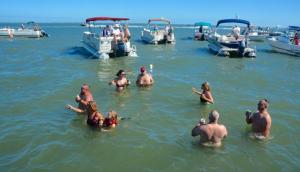 It’s not a typical wedding crowd by any stretch as guests party in the shallow bay waters or watch from nearby boats.