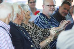 Anne Lynam accepts a red carnation recognizing herself and husband Richard for their 55 years of membership.