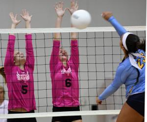 Sussex Tech front-liners Aliyah Browning and Megan Perdue go up to try for the block on Cape’s Maddy Holt.