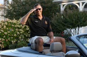 Rep. Steve Smyk salutes during the homecoming parade.