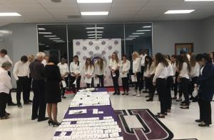 Before the banquet begins, National Honor Society members pray over the evening with DCHS science teacher John Jochum and Director of Admissions and Marketing Susan Gum.