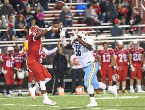 Cape defensive end Aarin Burton puts tough pressure on Smyrna quarterback Isaiah Wilson, causing him to throw an interception.