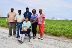 Standing with the Mountaire Millsboro plant in the background are Herbert Lane residents (l-r) James Reid, Junior Lee Wise, Preston Wise, Patsy Taylor, Faye Burton and Martha Wise (in front). They said Mountaire has not been a good neighbor, and should not be allowed to expand its operations. MADDY LAURIA PHOTO