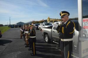 American Legion bugler Allen Drake plays “Taps” after the American Legion Honor Guard fired a salute. AL Post 28