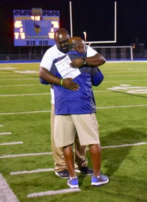 Cape assistant coach Billy Collick, left, shares a touching moment with his dad as the game winds down.