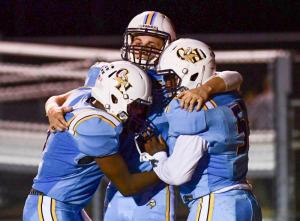 Cape wide receiver Zach Dale, center, gets a celebratory hug after his touchdown with quarterback Sam Jones, left, and lineman Jordan Jones.