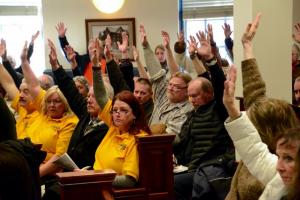 Some of those opposed to the ordinance raise their hands. About three-quarters of the standing-room only crowd was opposed to the ordinance.