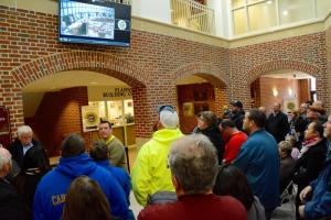 With no room left in council chambers, some of those attending the public hearing have to stand in the lobby and watch the live feed of the meeting,