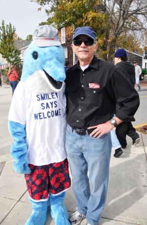 Rehoboth Beach-Dewey Beach Chamber of Commerce mascot Smiley the Dolphin and Bruce Pringle greet guests. BY NICK ROTH