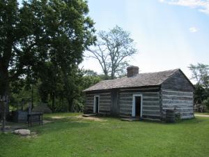 Here's the cabin of Thomas Lincoln, father of Abe. To the left is the well where perishable foods were lowered in the summer to be kept fresher in the steady 54-degree temperature.