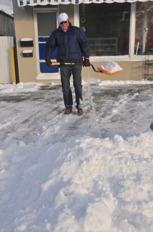 Gary Turton, owner of Rehoboth Beach Variety blames the wind for piling up snow in front of his business. BY RON MACARTHUR