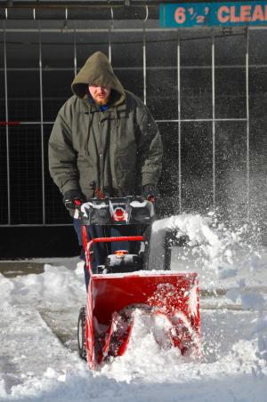 Brandon Robertson, who works for Brighton Suites in Rehoboth Beach, says this is the first time he's been able to use a snow blower. BY RON MACARTHUR