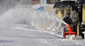 Keith Martin, owner of Hotel Rehoboth in Rehoboth Beach, uses a snow blower to make quick work of snow piled in front of businesses. BY RON MACARTHUR