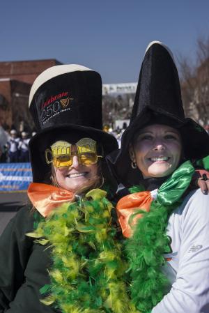 Vanessa Cooper, left, and Charlene Jones wear top hats and green feather boas for the stroll down Union Street. BY DENY HOWETH