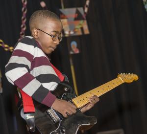 Eldre Gladney, 14, plays nine different instruments and chose his guitar to perform for this event. BY DENY HOWETH