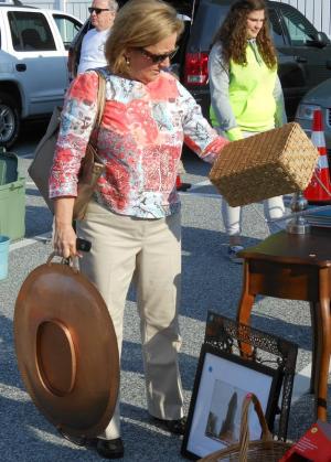 Cindy Wolfe of Lewes decides whether or not this basket will be joining the large plate as part of the bounty from the Treasure Fest. BY CHRIS FLOOD