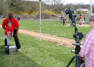 Father Dwight Tingle and son Jameson take the classic baseball card picture at Rehoboth Little Leagues 2014 opening day. BY PAT IRELAN