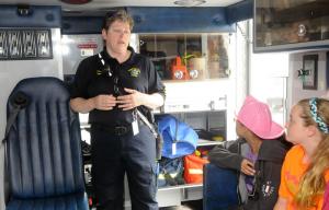 Inside the new Georgetown American Legion ambulance, EMS Supervisor Deanna Loeb answers questions from students at Georgetown Elementary. Enjoying their experience in the ambulance are Alana James, center, and Jasmine Hundley. BY STEVEN BILLUPS