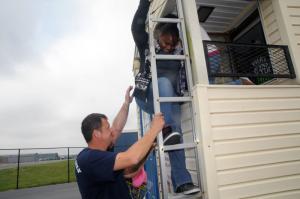 Escaping from a smoke-filled Fire Safety House provided by Blades Volunteer Fire Company is Trinity Styles from Fredrick Douglas Elementary with help from Firefighter Chad Lecates. BY STEVEN BILLUPS
